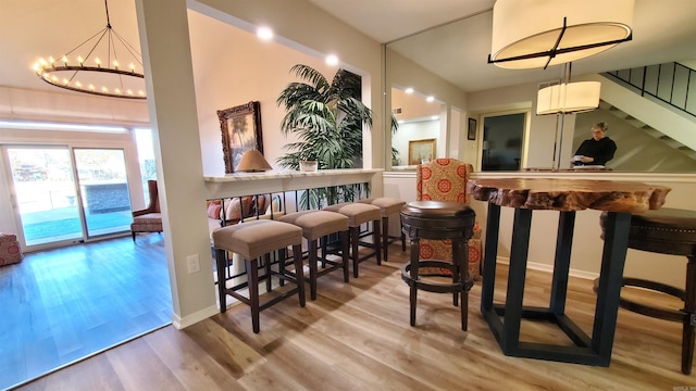 24 Fairway Woods Cir, Maumelle, AR 72113 - indoor dry bar featuring a chandelier, stairway, and wood finished floors