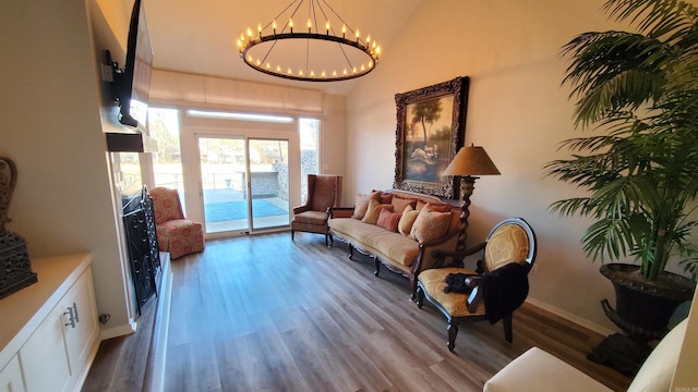 24 Fairway Woods Cir, Maumelle, AR 72113 - living area featuring wood finished floors, a chandelier, lofted ceiling, and baseboards