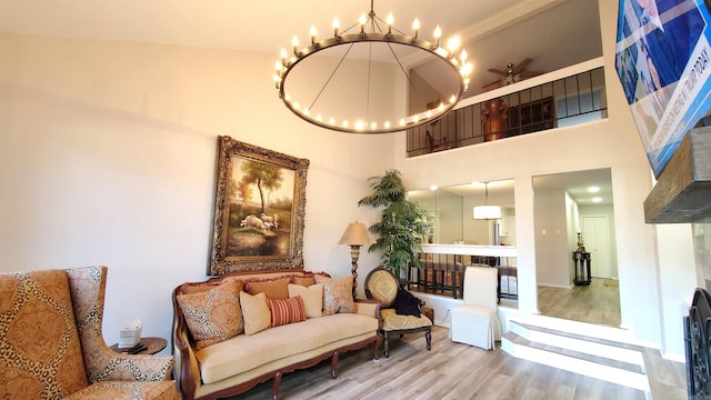 24 Fairway Woods Cir, Maumelle, AR 72113 - living area with a chandelier, wood finished floors, a towering ceiling, and ceiling fan