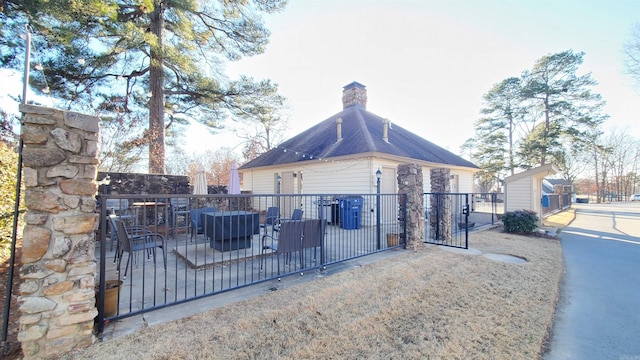 24 Fairway Woods Cir, Maumelle, AR 72113 - view of side of property featuring a chimney and a gate