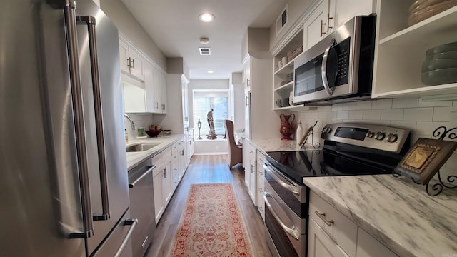 24 Fairway Woods Cir, Maumelle, AR 72113 - kitchen with appliances with stainless steel finishes, open shelves, a sink, wood finished floors, and white cabinets