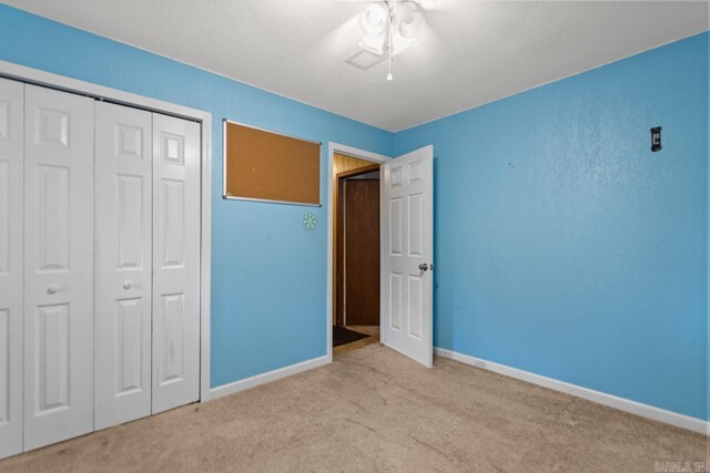 766 Grant 735 Rd, Sheridan, AR 72150 - unfurnished bedroom with carpet, baseboards, a closet, and a ceiling fan