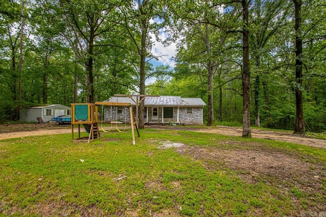 766 Grant 735 Rd, Sheridan, AR 72150 - view of front facade featuring stone siding, metal roof, and a front yard