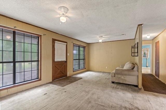 766 Grant 735 Rd, Sheridan, AR 72150 - carpeted foyer entrance featuring a ceiling fan, a textured ceiling, and wooden walls