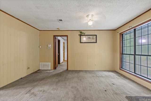 766 Grant 735 Rd, Sheridan, AR 72150 - carpeted spare room with crown molding, a ceiling fan, a textured ceiling, and wood walls