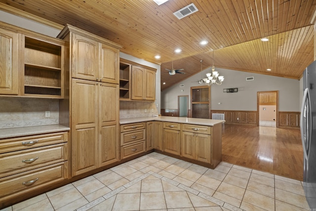 645 Drye Rd, Biscoe, AR 72017 - kitchen with open shelves, a wainscoted wall, light countertops, light tile patterned flooring, and a peninsula