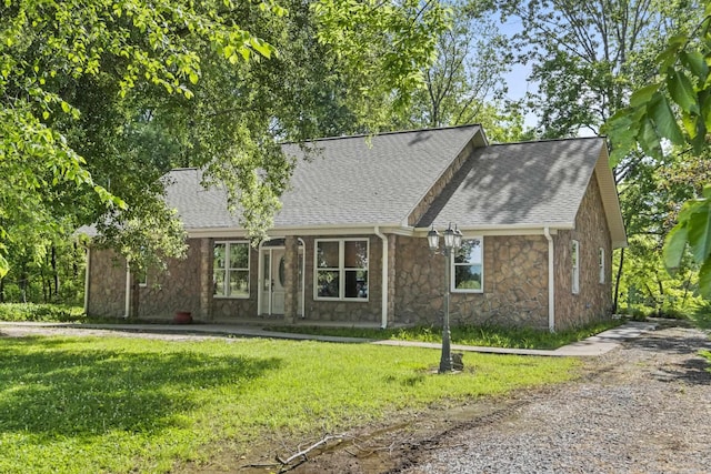 645 Drye Rd, Biscoe, AR 72017 - view of front of home with stone siding, roof with shingles, and a front yard