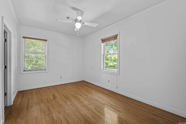 645 Drye Rd, Biscoe, AR 72017 - unfurnished bedroom featuring multiple windows, light wood-style floors, baseboards, ornamental molding, and ceiling fan