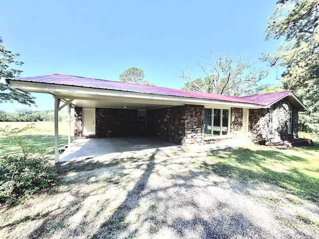 2174 N Main St, Melbourne, AR 72556 - view of front of property with stone siding, driveway, an attached carport, metal roof, and a front lawn