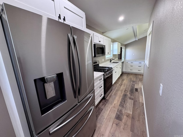 2174 N Main St, Melbourne, AR 72556 - kitchen with stainless steel appliances, a sink, light countertops, dark wood finished floors, and white cabinets