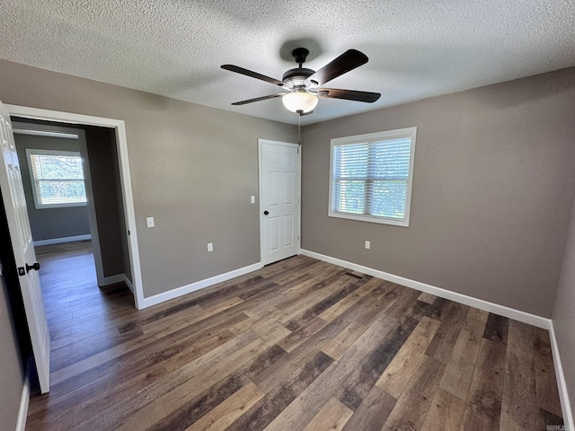 2174 N Main St, Melbourne, AR 72556 - unfurnished bedroom with wood finished floors, baseboards, a textured ceiling, and a ceiling fan