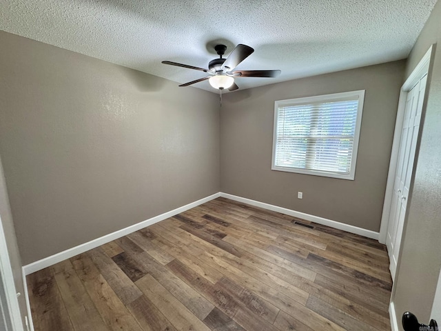 2174 N Main St, Melbourne, AR 72556 - unfurnished bedroom featuring hardwood / wood-style flooring, baseboards, a textured ceiling, a ceiling fan, and a closet
