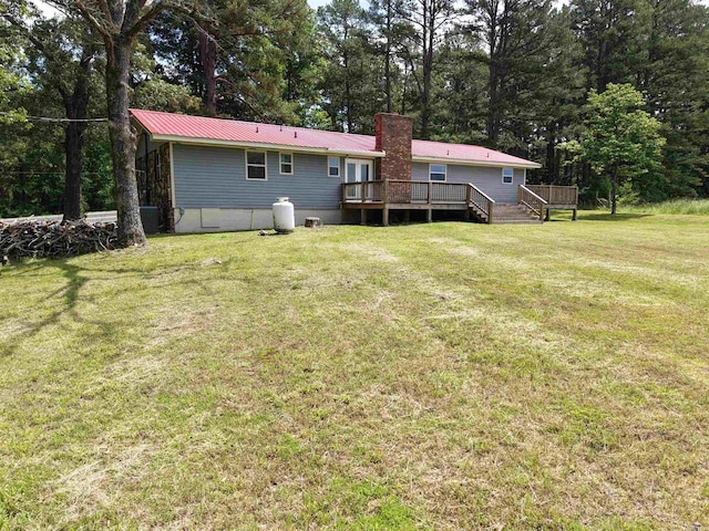 2174 N Main St, Melbourne, AR 72556 - back of house featuring a deck, metal roof, a lawn, a chimney, and view of scattered trees