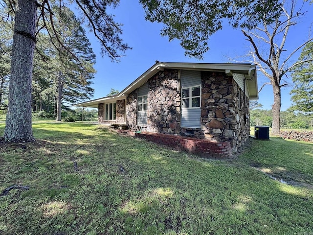 2174 N Main St, Melbourne, AR 72556 - view of home's exterior with stone siding, cooling unit, and a lawn