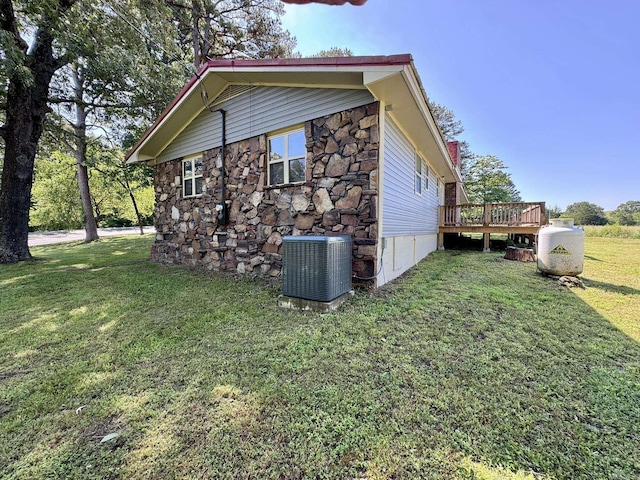 2174 N Main St, Melbourne, AR 72556 - view of property exterior with central AC unit, a wooden deck, a yard, and stone siding