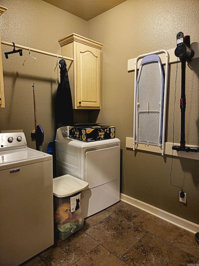 2000 Boundary Oaks Dr, Jonesboro, AR 72404 - washroom featuring washing machine and clothes dryer, cabinet space, dark stone finish flooring, and baseboards