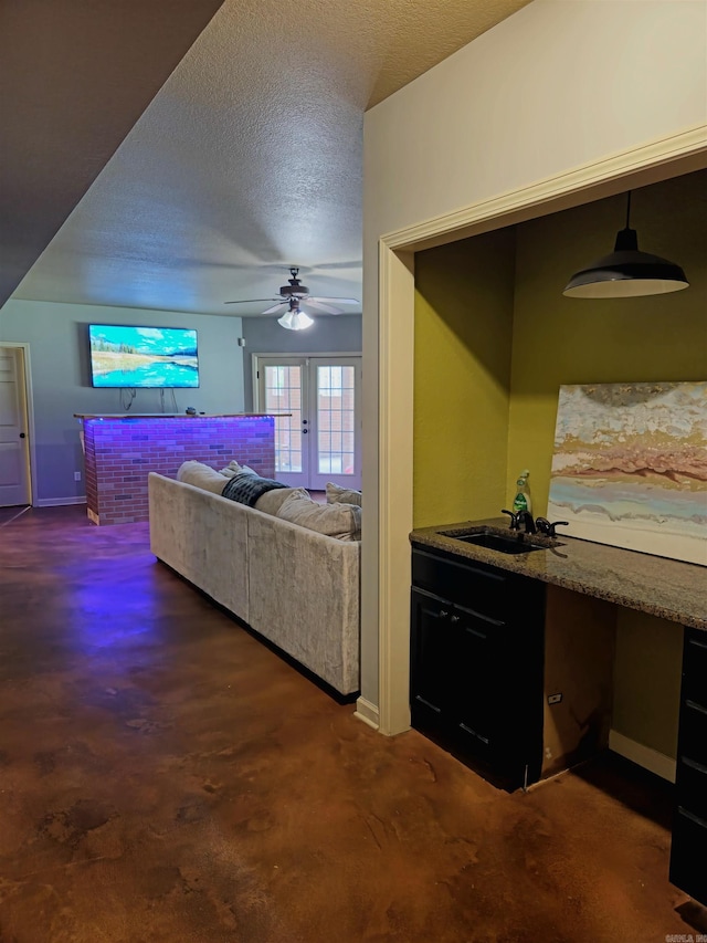 2000 Boundary Oaks Dr, Jonesboro, AR 72404 - living area featuring ceiling fan, a textured ceiling, baseboards, and dark colored carpet