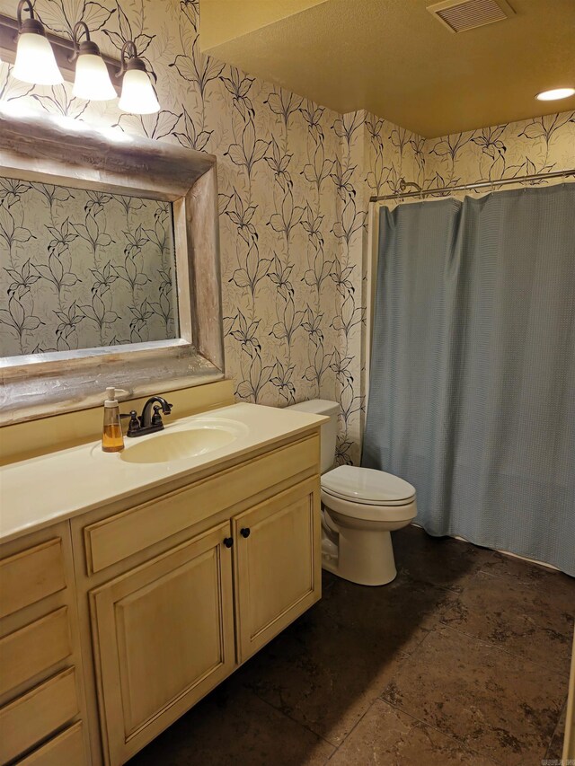 2000 Boundary Oaks Dr, Jonesboro, AR 72404 - bathroom with wallpapered walls, vanity, and toilet