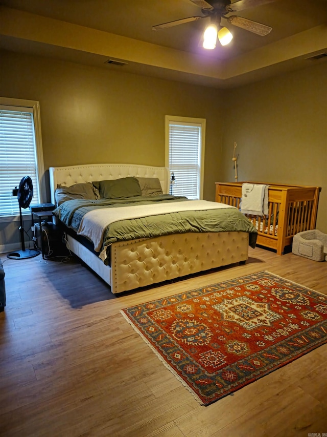 2000 Boundary Oaks Dr, Jonesboro, AR 72404 - bedroom featuring wood finished floors, multiple windows, and ceiling fan