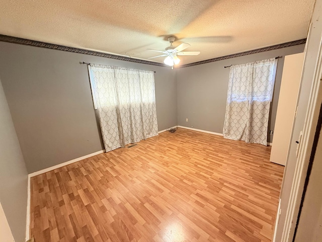 147 Winfree Ln, Melbourne, AR 72556 - spare room featuring ceiling fan, light wood-type flooring, a textured ceiling, and baseboards