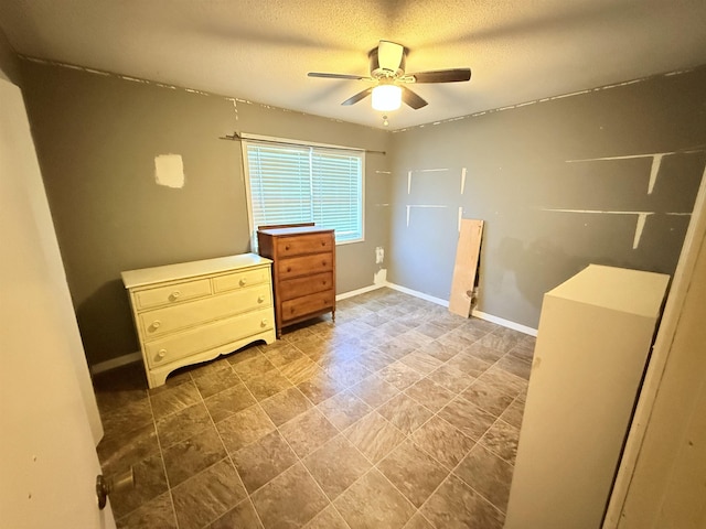 147 Winfree Ln, Melbourne, AR 72556 - unfurnished bedroom featuring a ceiling fan, baseboards, and a textured ceiling