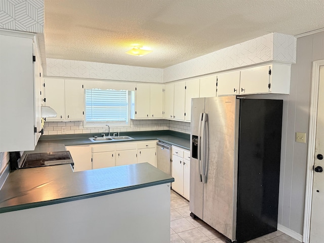 147 Winfree Ln, Melbourne, AR 72556 - kitchen with appliances with stainless steel finishes, a sink, under cabinet range hood, a peninsula, and dark countertops