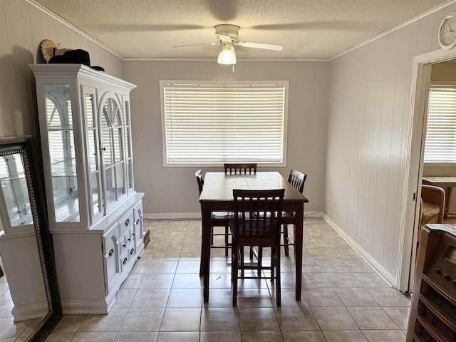 147 Winfree Ln, Melbourne, AR 72556 - dining space with ornamental molding, ceiling fan, a textured ceiling, light tile patterned floors, and wood walls