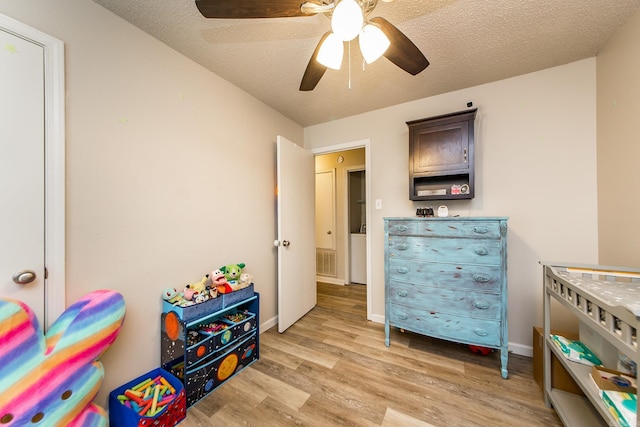 13 Fieldcrest Ln, Cabot, AR 72023 - bedroom with light wood finished floors, a textured ceiling, a ceiling fan, and baseboards