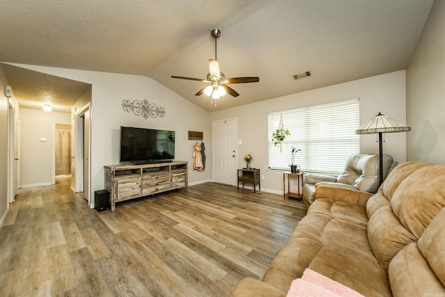 13 Fieldcrest Ln, Cabot, AR 72023 - living room with wood finished floors, vaulted ceiling, a ceiling fan, a textured ceiling, and baseboards