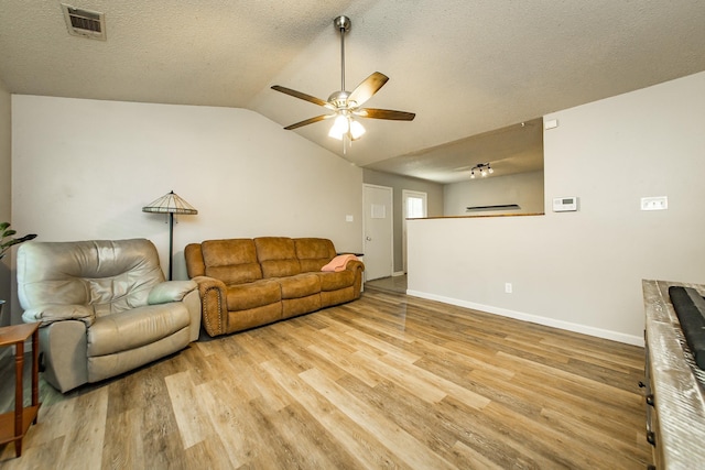 13 Fieldcrest Ln, Cabot, AR 72023 - living area with ceiling fan, light wood-type flooring, vaulted ceiling, a textured ceiling, and baseboards