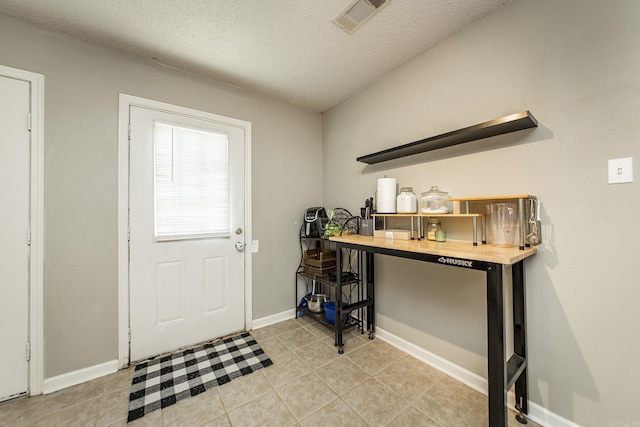 13 Fieldcrest Ln, Cabot, AR 72023 - entryway with light tile patterned flooring, a textured ceiling, and baseboards