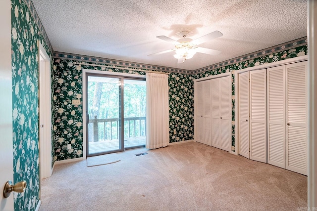265 Zebulin Dr, Heber Springs, AR 72543 - unfurnished bedroom with wallpapered walls, carpet, access to exterior, a textured ceiling, and baseboards