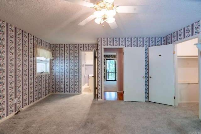 265 Zebulin Dr, Heber Springs, AR 72543 - unfurnished bedroom featuring wallpapered walls, a textured ceiling, carpet floors, and a ceiling fan