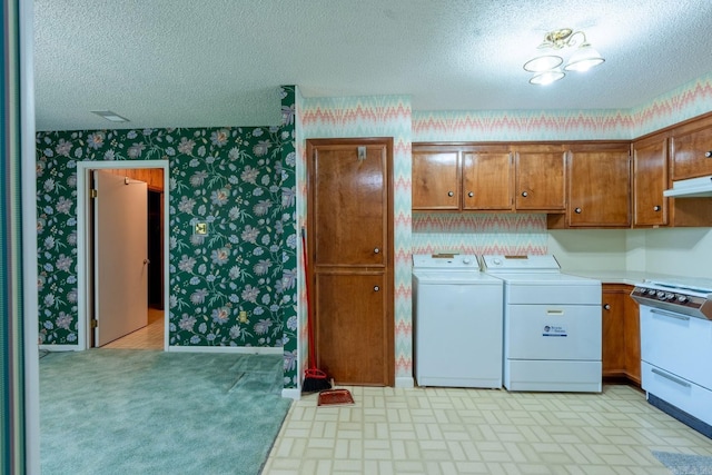 265 Zebulin Dr, Heber Springs, AR 72543 - laundry room featuring wallpapered walls, washing machine and clothes dryer, a textured ceiling, and brick patterned flooring