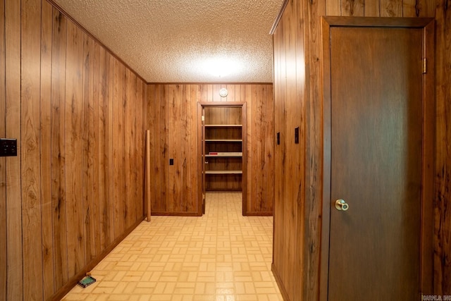 265 Zebulin Dr, Heber Springs, AR 72543 - corridor with wooden walls, brick patterned floors, and a textured ceiling