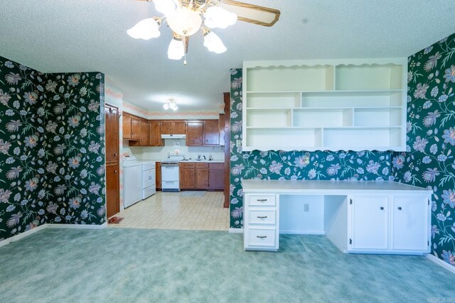 265 Zebulin Dr, Heber Springs, AR 72543 - kitchen featuring wallpapered walls, white range oven, washer / dryer, light countertops, and brown cabinetry