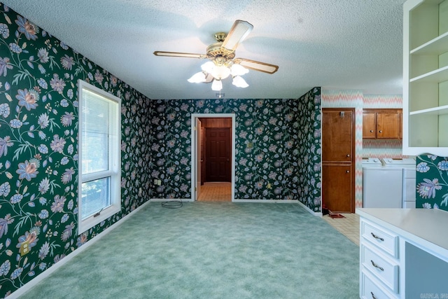 265 Zebulin Dr, Heber Springs, AR 72543 - unfurnished living room featuring independent washer and dryer, wallpapered walls, a textured ceiling, ceiling fan, and light colored carpet