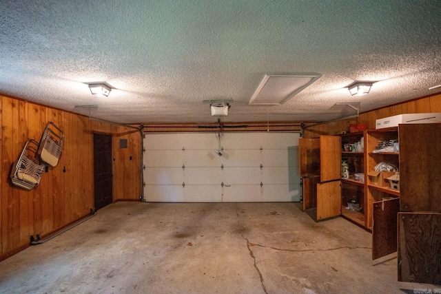 265 Zebulin Dr, Heber Springs, AR 72543 - garage with wood walls and a garage door opener