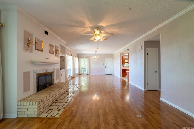 265 Zebulin Dr, Heber Springs, AR 72543 - unfurnished living room featuring a fireplace, wood finished floors, ceiling fan, a chandelier, and crown molding