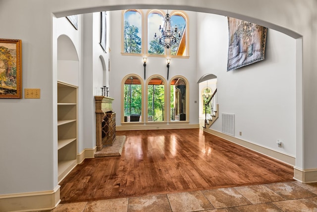 31 Cravache Ct, Little Rock, AR 72223 - entryway with a towering ceiling, stairs, baseboards, a chandelier, and arched walkways