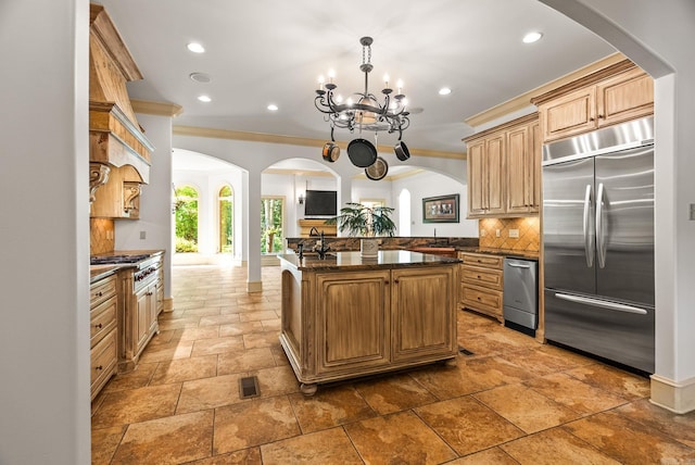 31 Cravache Ct, Little Rock, AR 72223 - kitchen featuring appliances with stainless steel finishes, decorative backsplash, recessed lighting, arched walkways, and stone tile floors