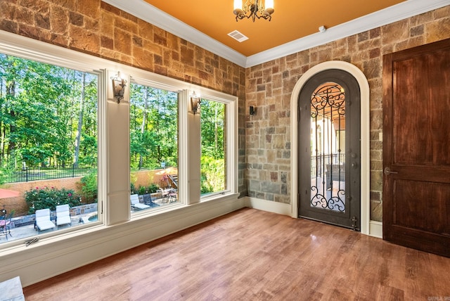 31 Cravache Ct, Little Rock, AR 72223 - foyer with crown molding, wood finished floors, arched walkways, and a chandelier
