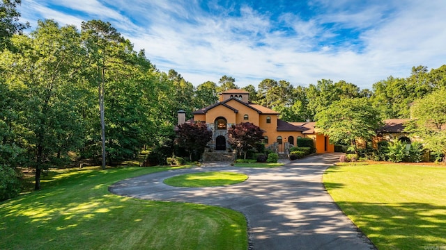 31 Cravache Ct, Little Rock, AR 72223 - mediterranean / spanish-style house with curved driveway, stucco siding, and a front yard