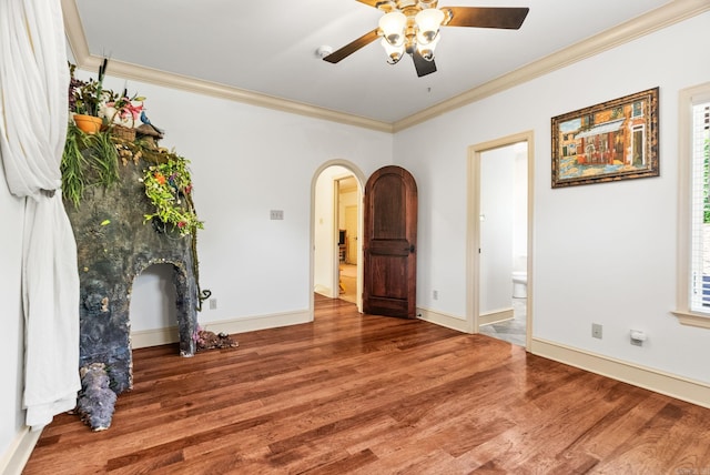 31 Cravache Ct, Little Rock, AR 72223 - empty room with arched walkways, ceiling fan, ornamental molding, wood finished floors, and baseboards
