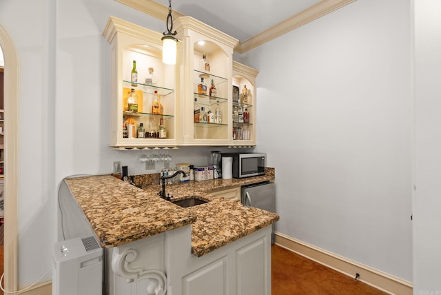 31 Cravache Ct, Little Rock, AR 72223 - indoor wet bar with crown molding, stainless steel microwave, hanging light fixtures, baseboards, and arched walkways