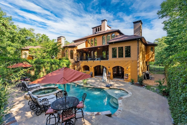 31 Cravache Ct, Little Rock, AR 72223 - back of property featuring a patio area, an in-ground hot tub, a balcony, a chimney, and an outdoor pool