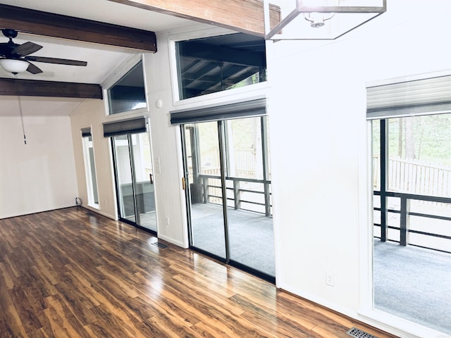 unfurnished room featuring beam ceiling, wood finished floors, and ceiling fan