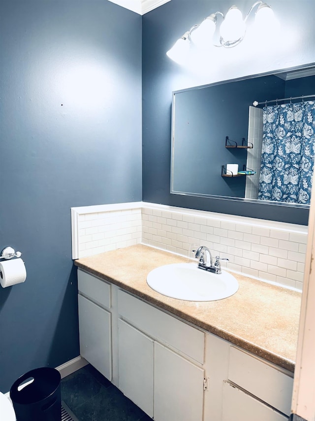 bathroom featuring vanity, tasteful backsplash, baseboards, and curtained shower