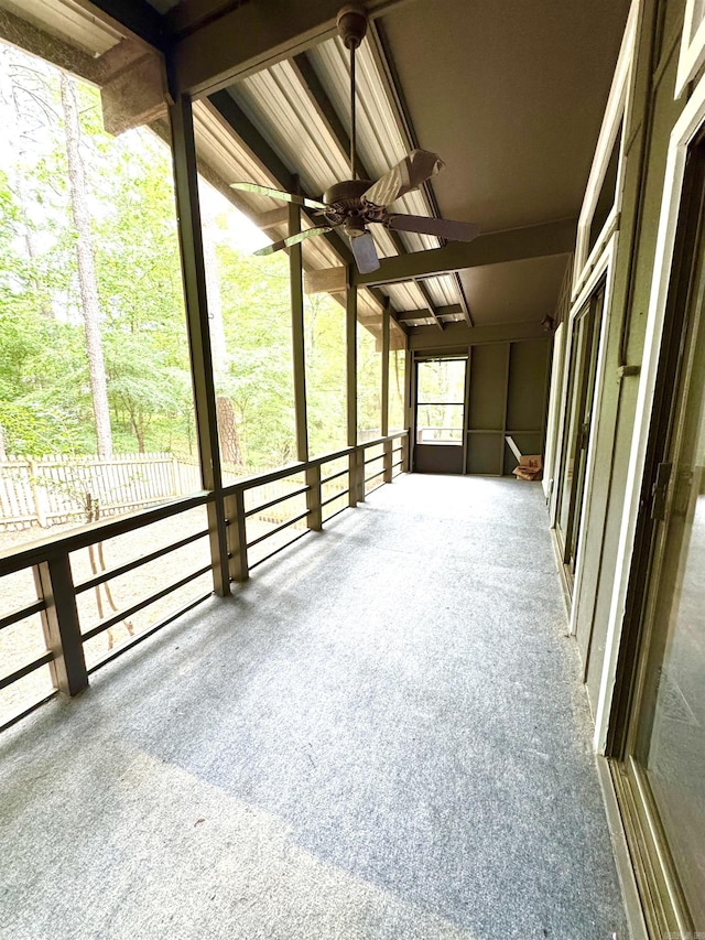 unfurnished sunroom with a ceiling fan