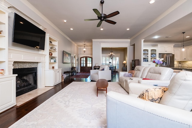 6 W Lake Ln, Little Rock, AR 72210 - living room featuring crown molding, dark wood-style flooring, a chandelier, ceiling fan, and a fireplace with flush hearth